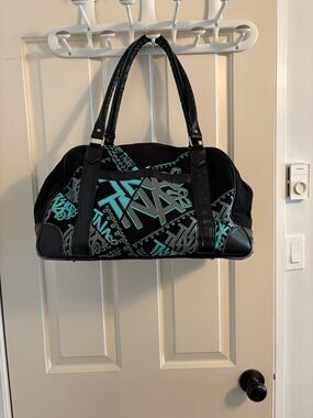 TNA Black and Teal Logo Travel Bag